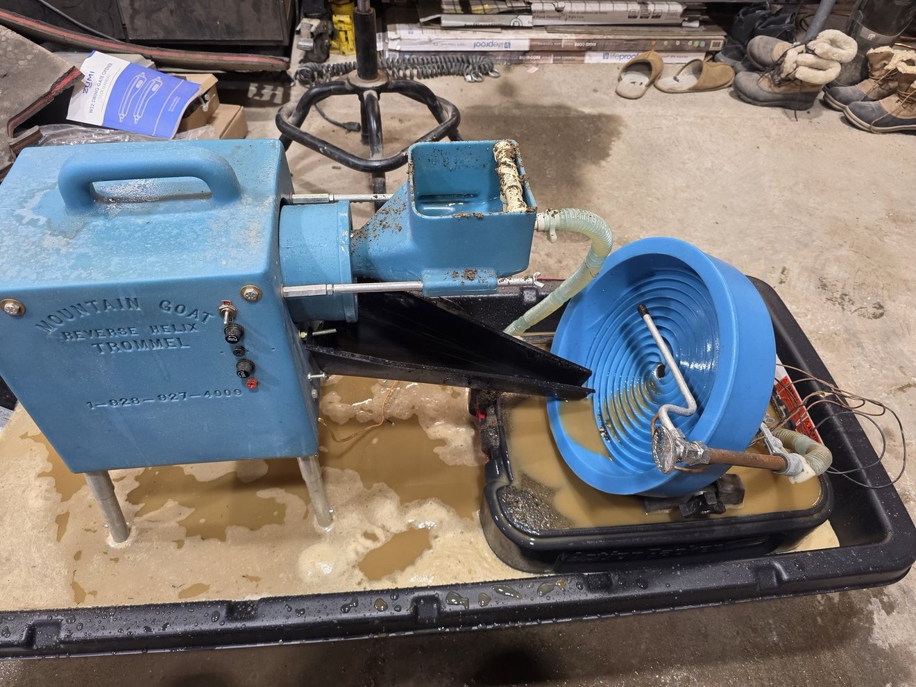 Blue recovery equipment and sluice setup at work.