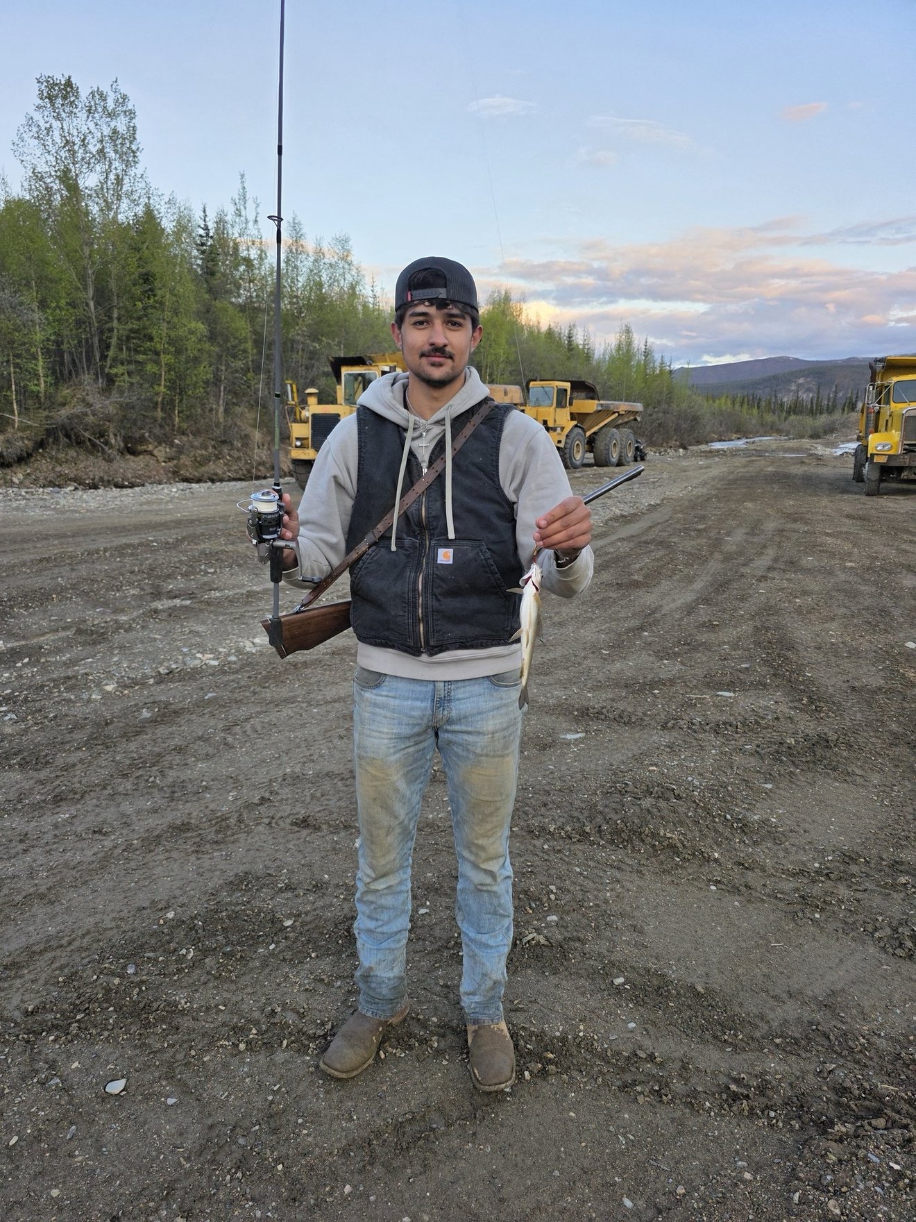 Portrait of a crew member on a dirt claim road.