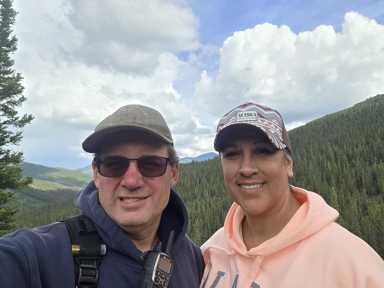 Two people taking a selfie in the mountains.