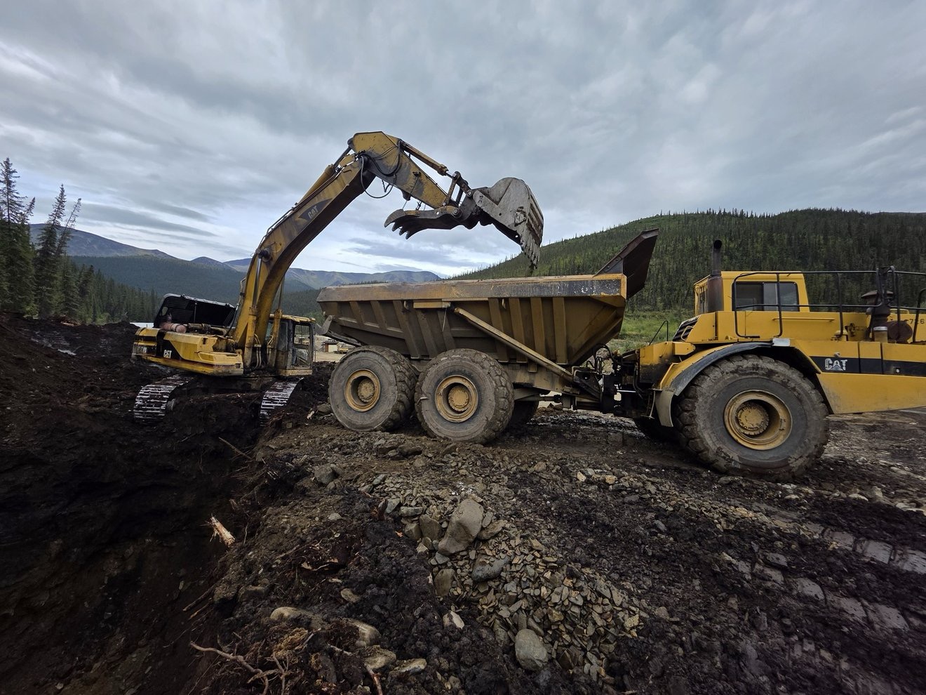Excavator loading material into a haul truck.