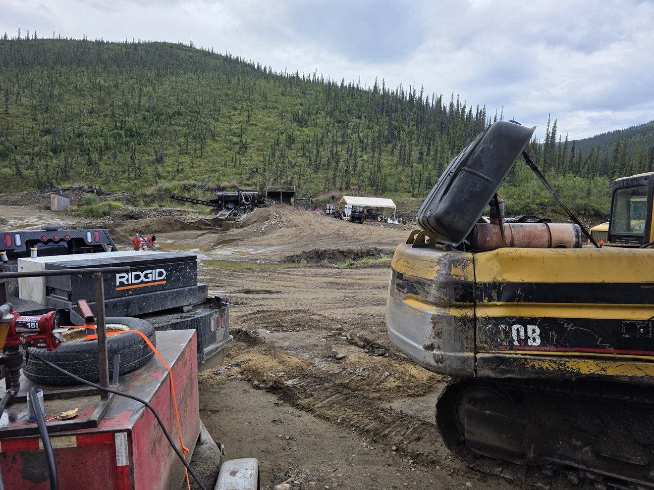 Excavator parked and working on the claim from the side.
