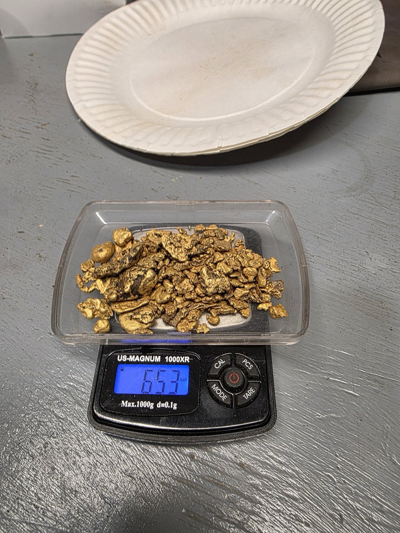 Gold nuggets weighed on a small digital scale.