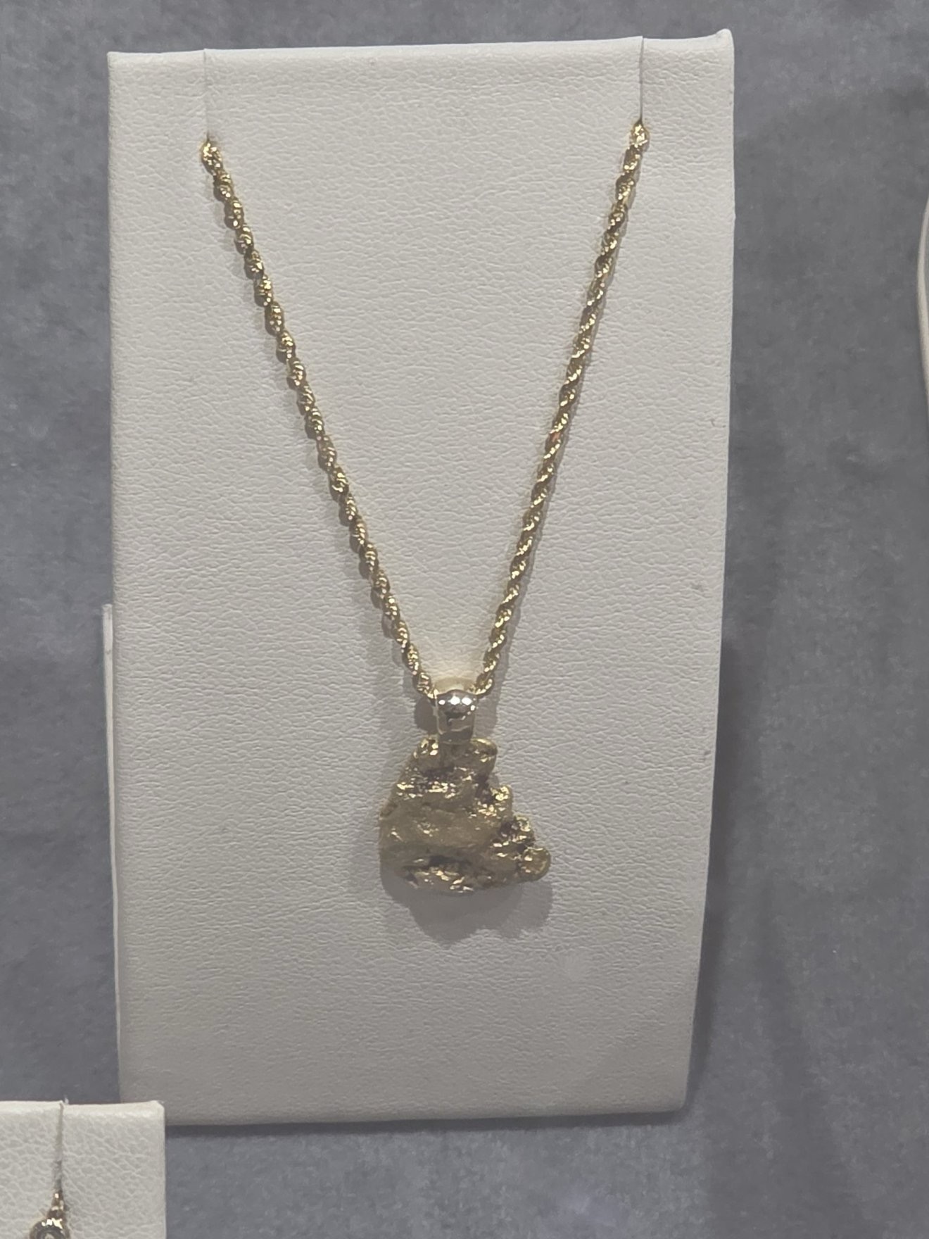 Close-up of a gold pendant necklace.