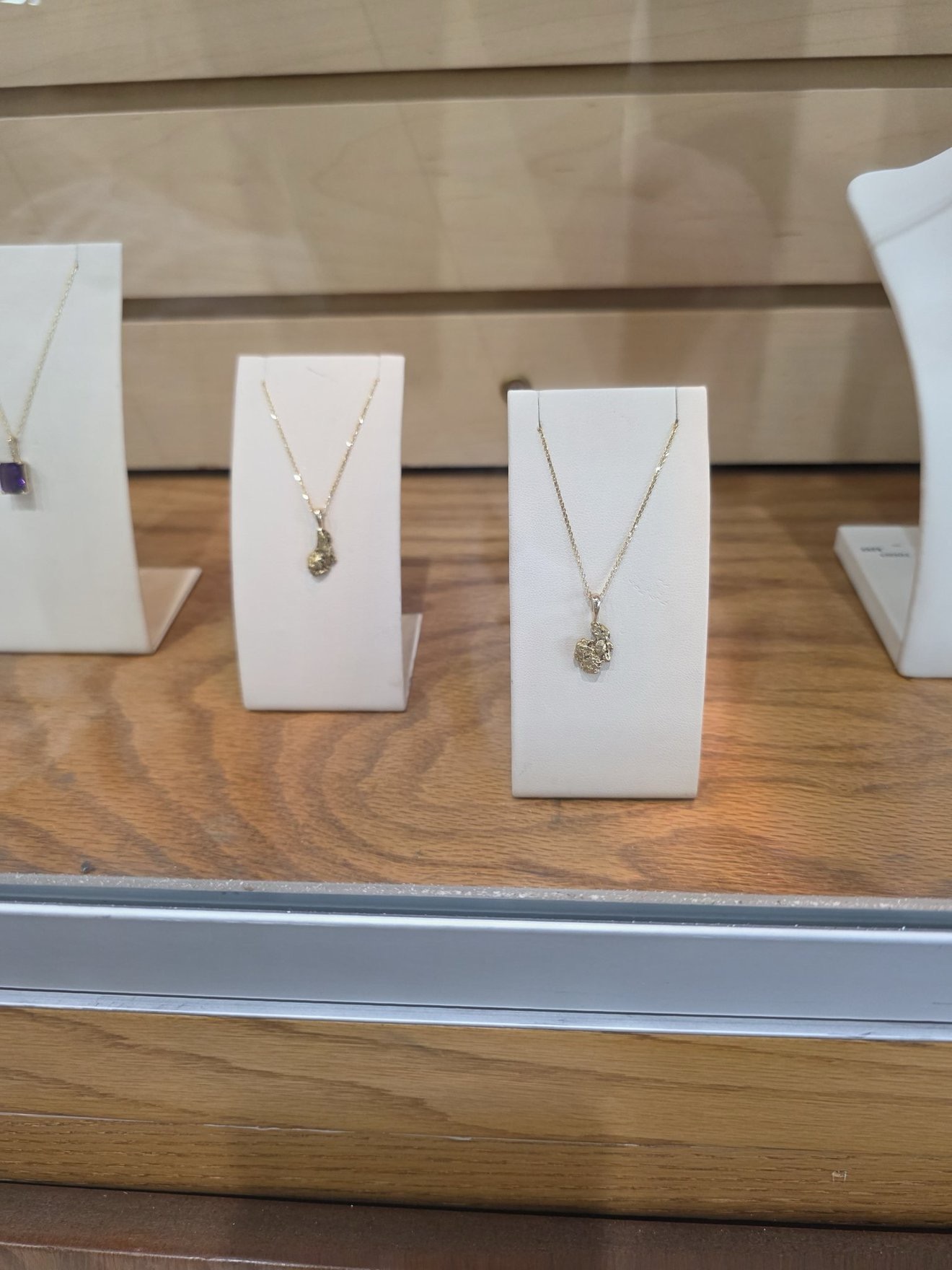 Jewelry display case with gold-themed pieces.