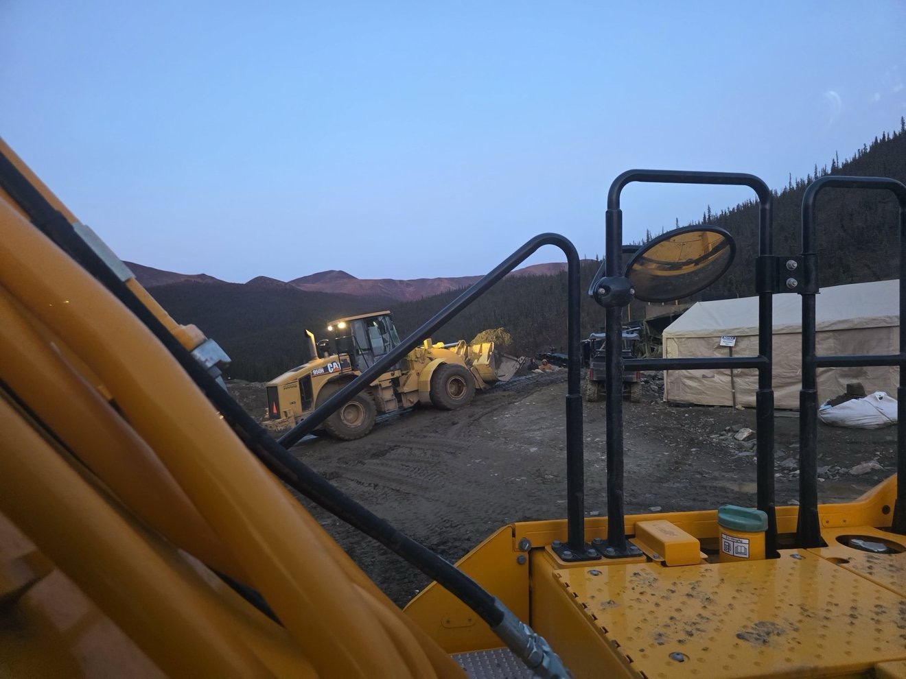 Loader parked on the claim at dusk.
