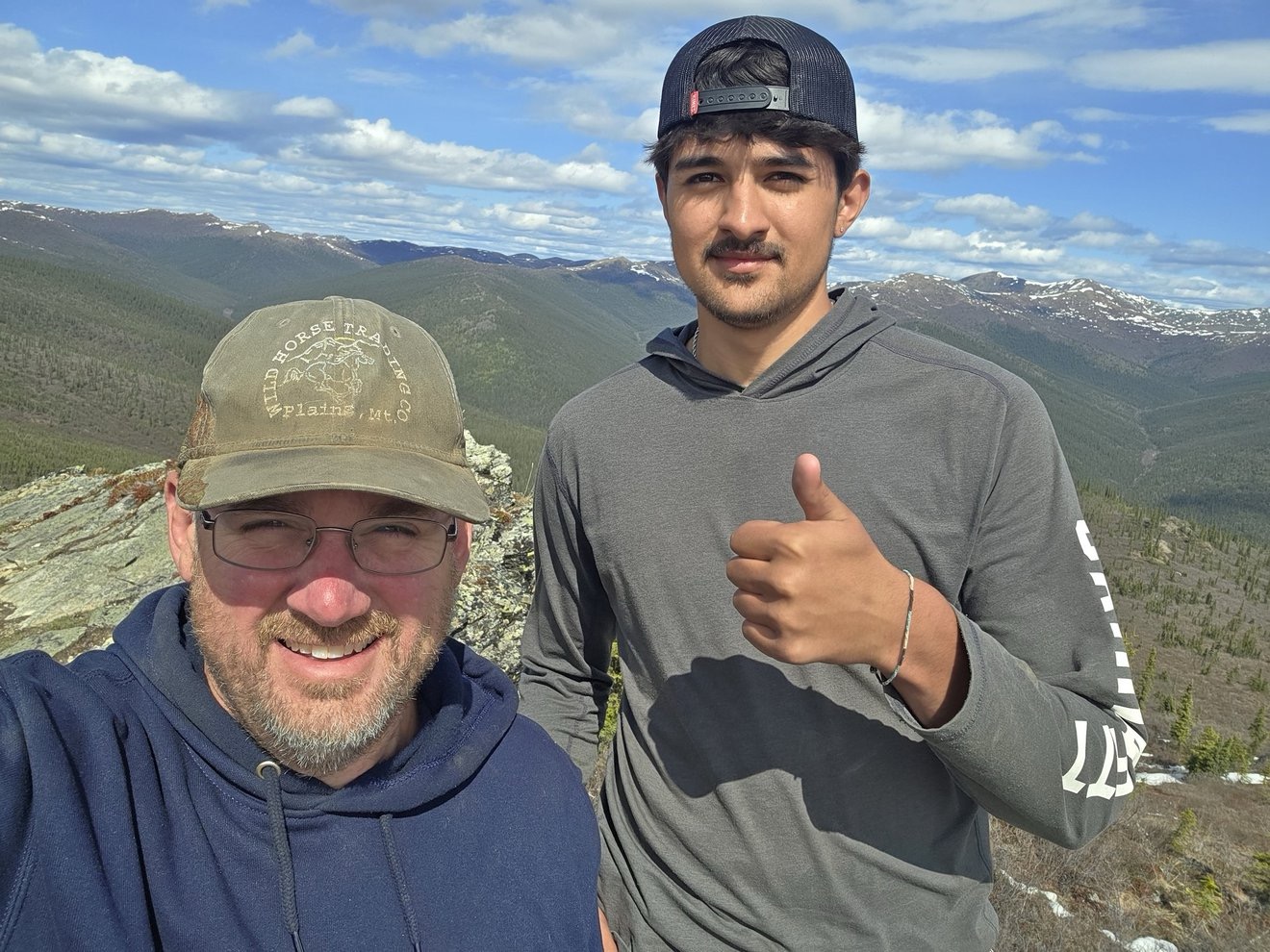 Two crew members taking a selfie high above the claim.