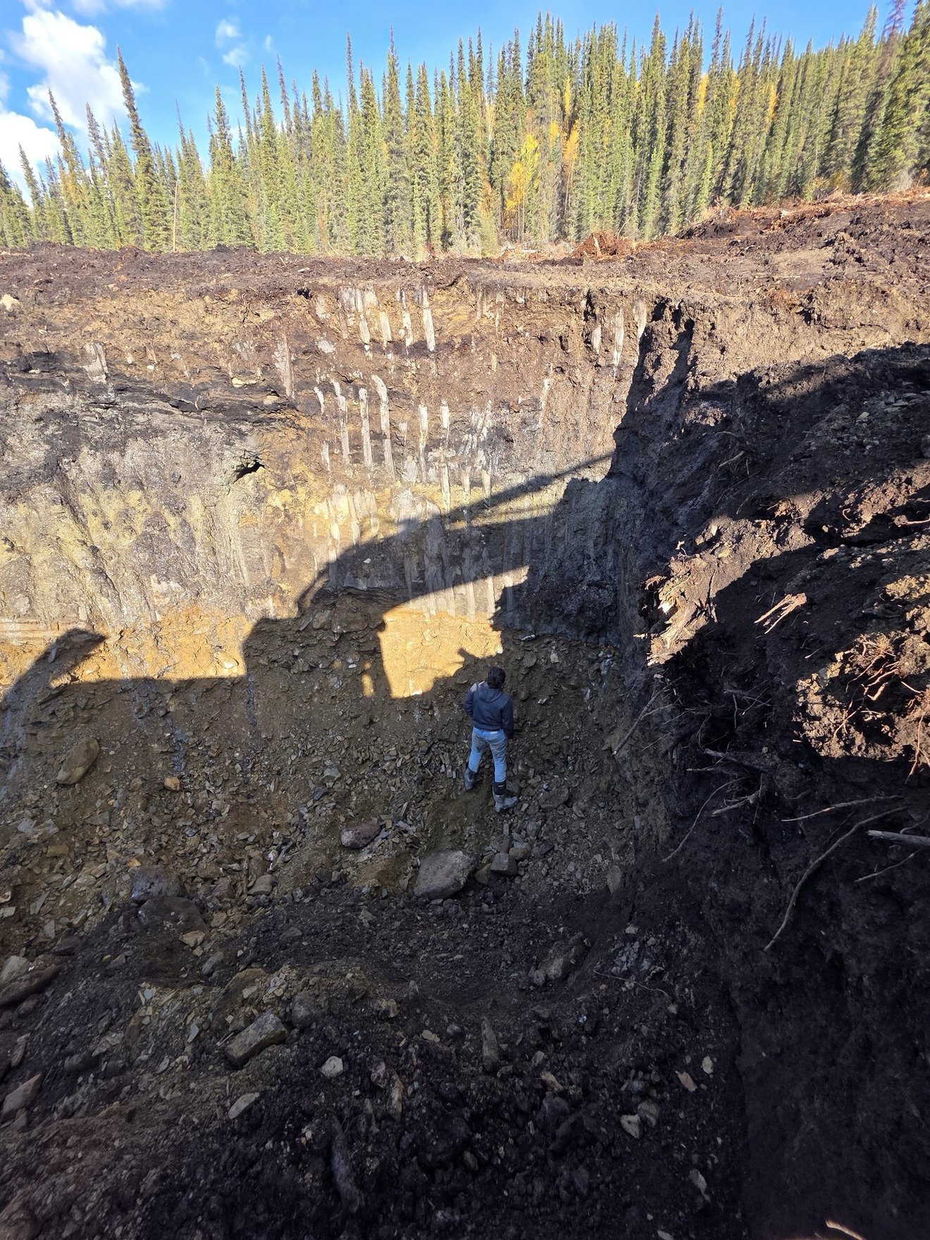 Open cut with visible claim wall and excavation below.