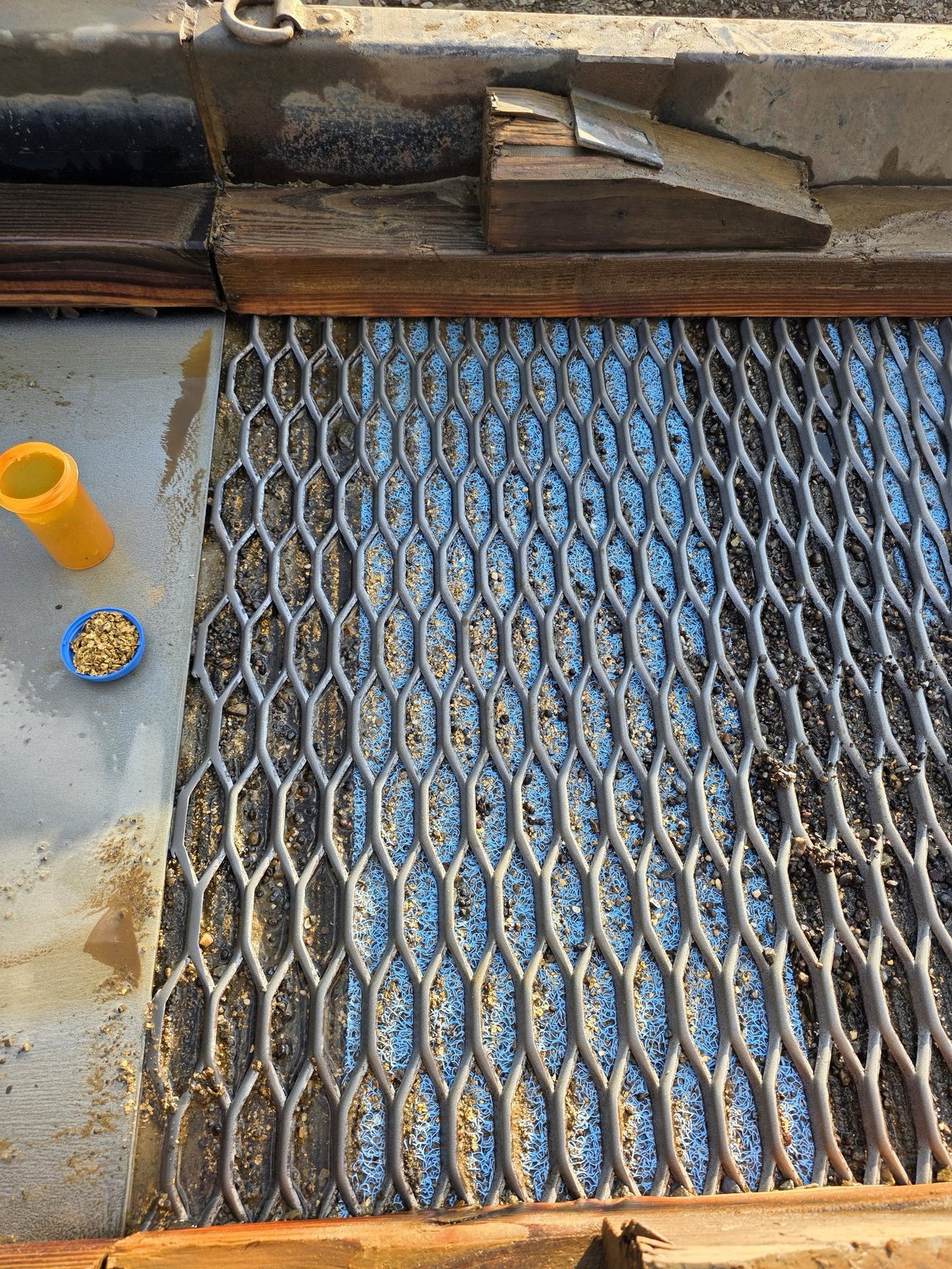 Freshly rinsed sluice riffles ready for recovery.