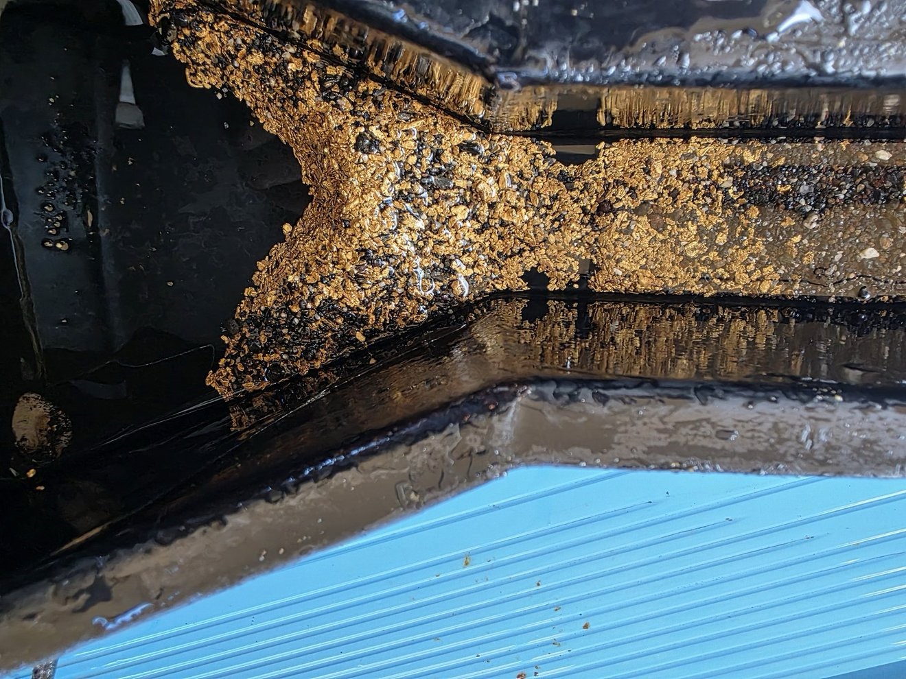 Gold visible in riffles during recovery.