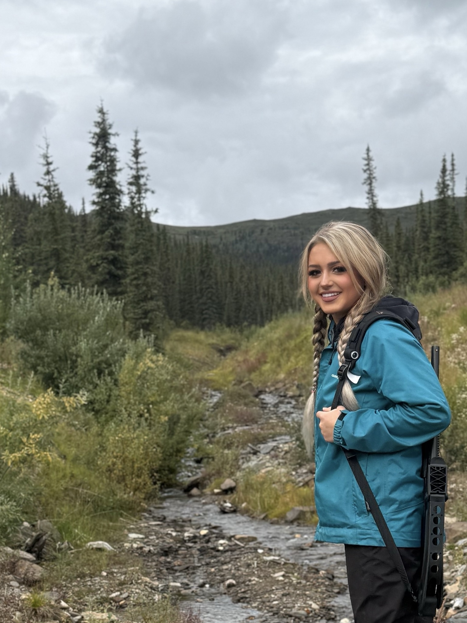 Portrait beside a creek in the mountains.